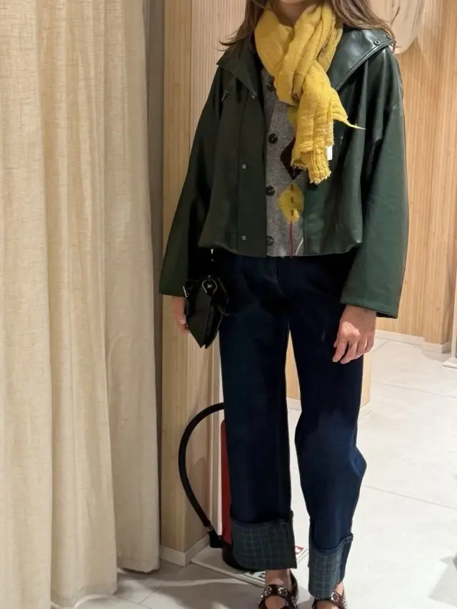 Green jacket, yellow scarf, dark cuffed jeans and burgundy shoes